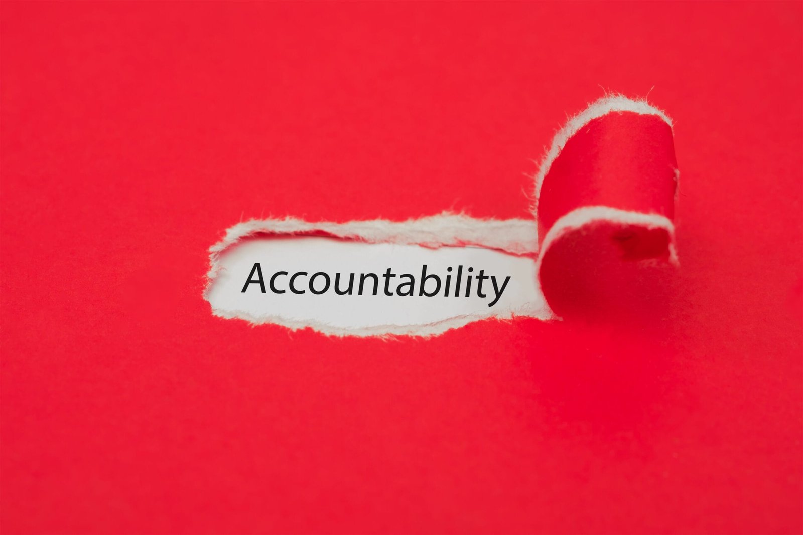 Torn red paper revealing the word of accountability concept